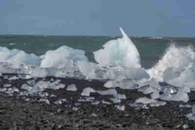 Icebergs from Jökulsárlón pushed back up onto the black sand beach at Diamond Beach