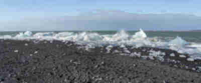 Icebergs from Jökulsárlón pushed back up onto the black sand beach at Diamond Beach