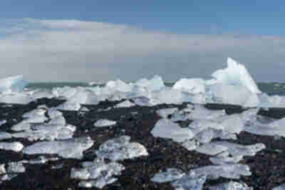 Icebergs from Jökulsárlón pushed back up onto the black sand beach at Diamond Beach