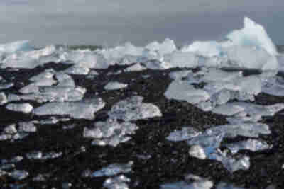 Icebergs from Jökulsárlón pushed back up onto the black sand beach at Diamond Beach
