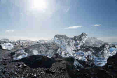 Icebergs from Jökulsárlón pushed back up onto the black sand beach at Diamond Beach