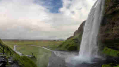 Hiking behind the Seljalandsfoss waterfall