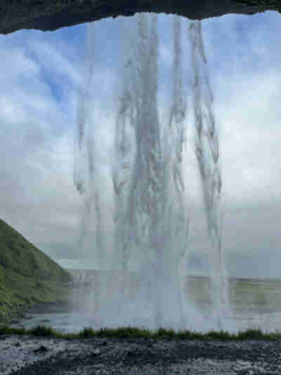 Hiking behind the Seljalandsfoss waterfall
