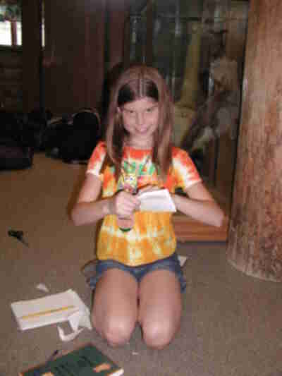 Melanie creating a paper flying machine