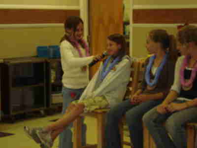 Megan interviewing Sarah about our day's activities during Wednesday night dinner.