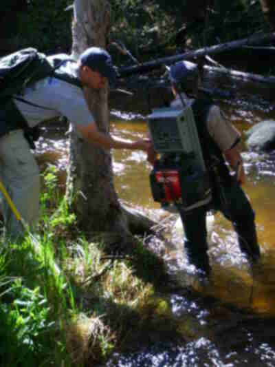 Aaron adjusting the current on the backpack shocker