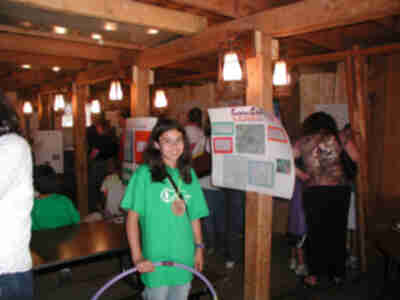 Caitie standing near her poster on Carrying Capacity