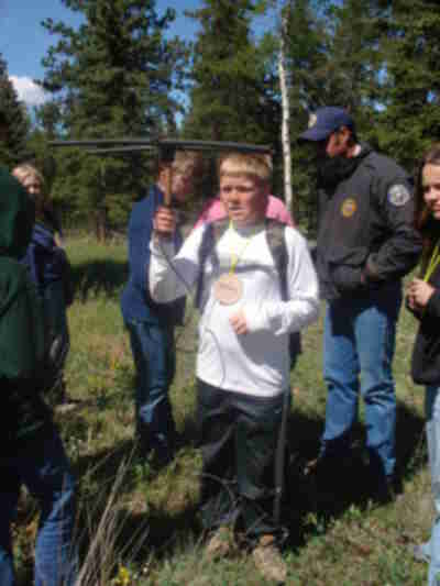 Dylan turning the receiver to determine where the signal is coming from