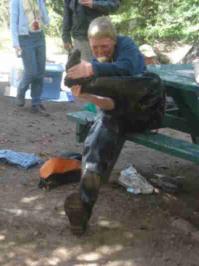 Dylan taking off the waders and eating a rice krispie treat
